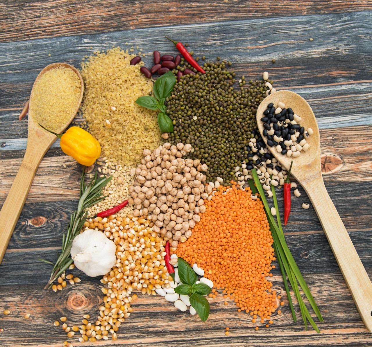 Assorted colorful Pakistani raw pulses and lentils in small clay bowls