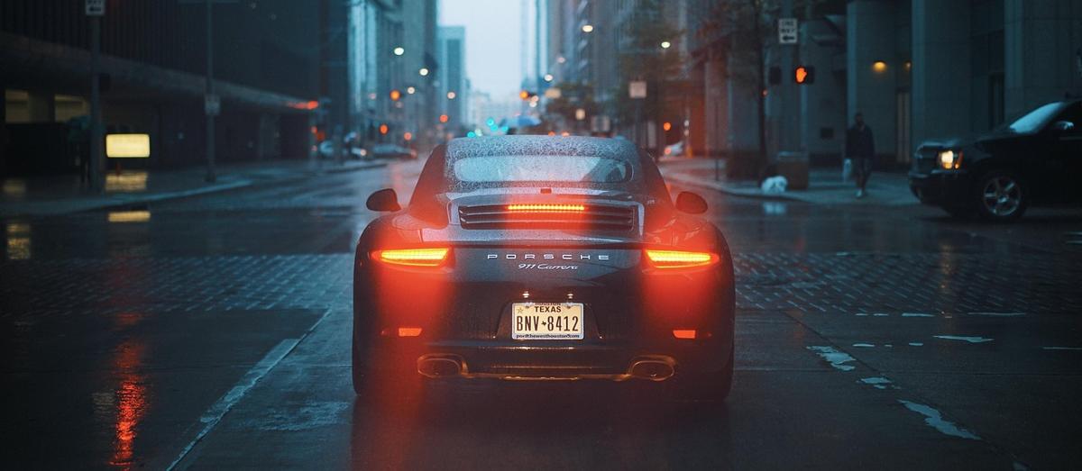View from inside a car driving through busy urban traffic during sunset