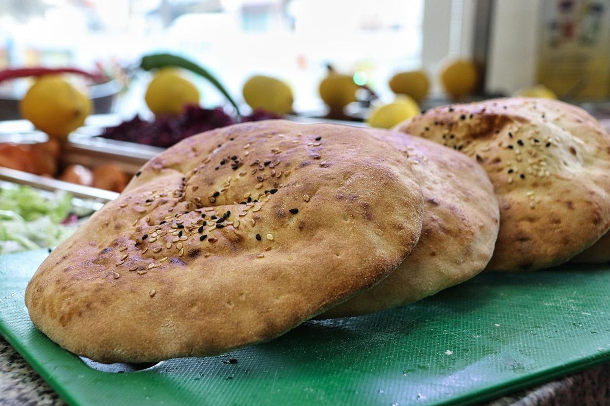 A Pakistani paratha served with yogurt, egg and vegetables