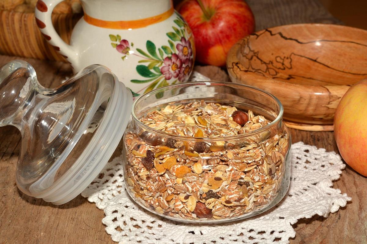 Cup of hot cardamom chai served alongside roasted chickpeas (bhuna chana) and almonds